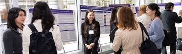 Students talking in front of their posters